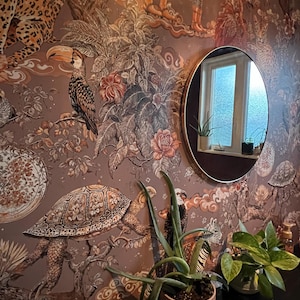 Customer photo — richly patterned wall with round mirror